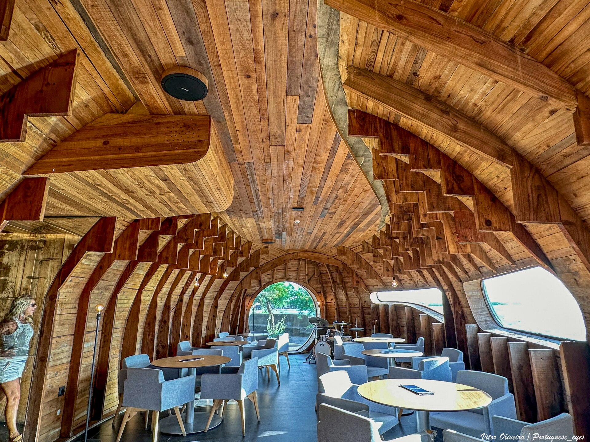 The curved timber and stone structure of the Cella Bar at Madalena