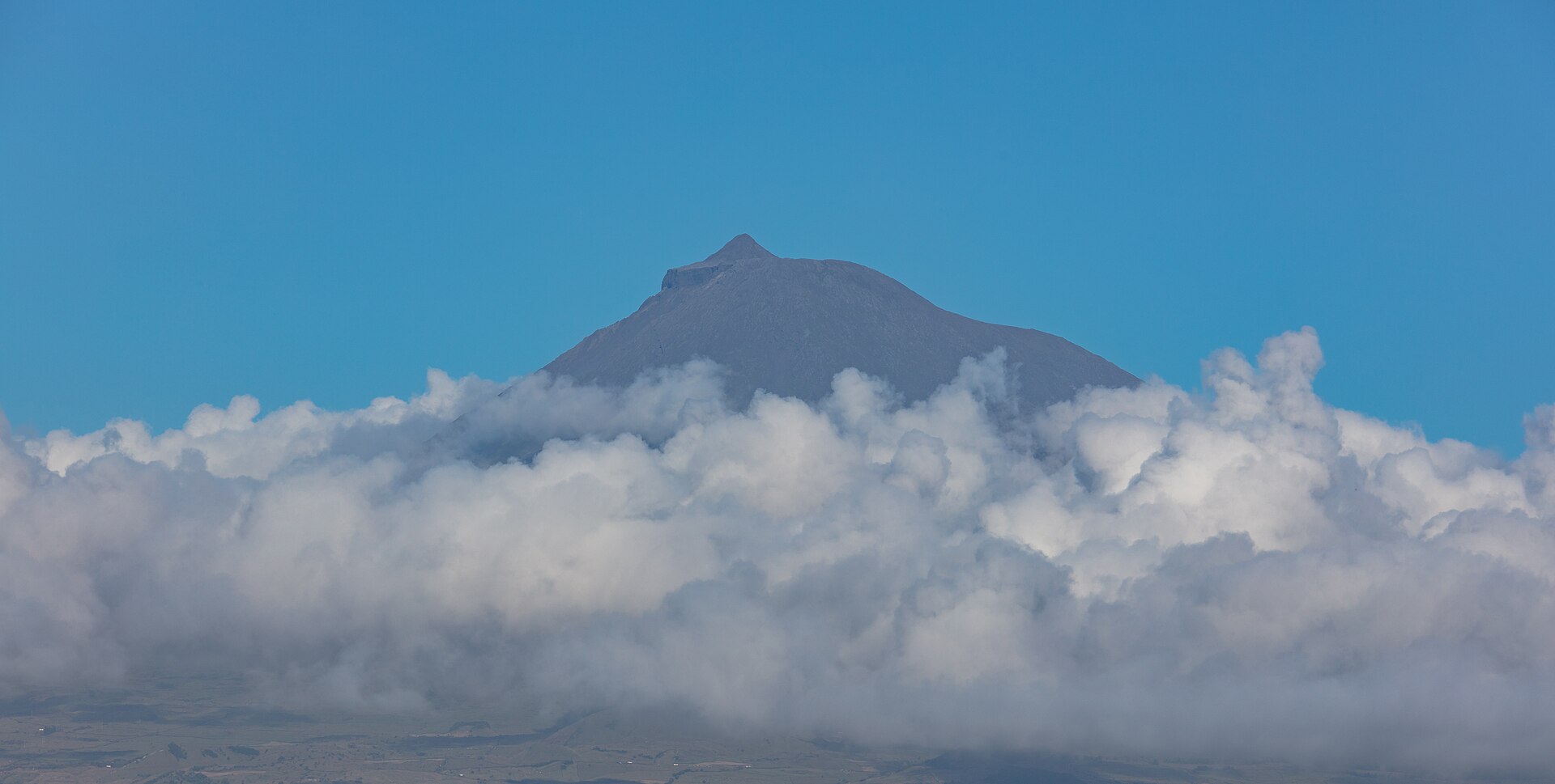 The cone of Montanha do Pico rising across the channel, seen from Faial